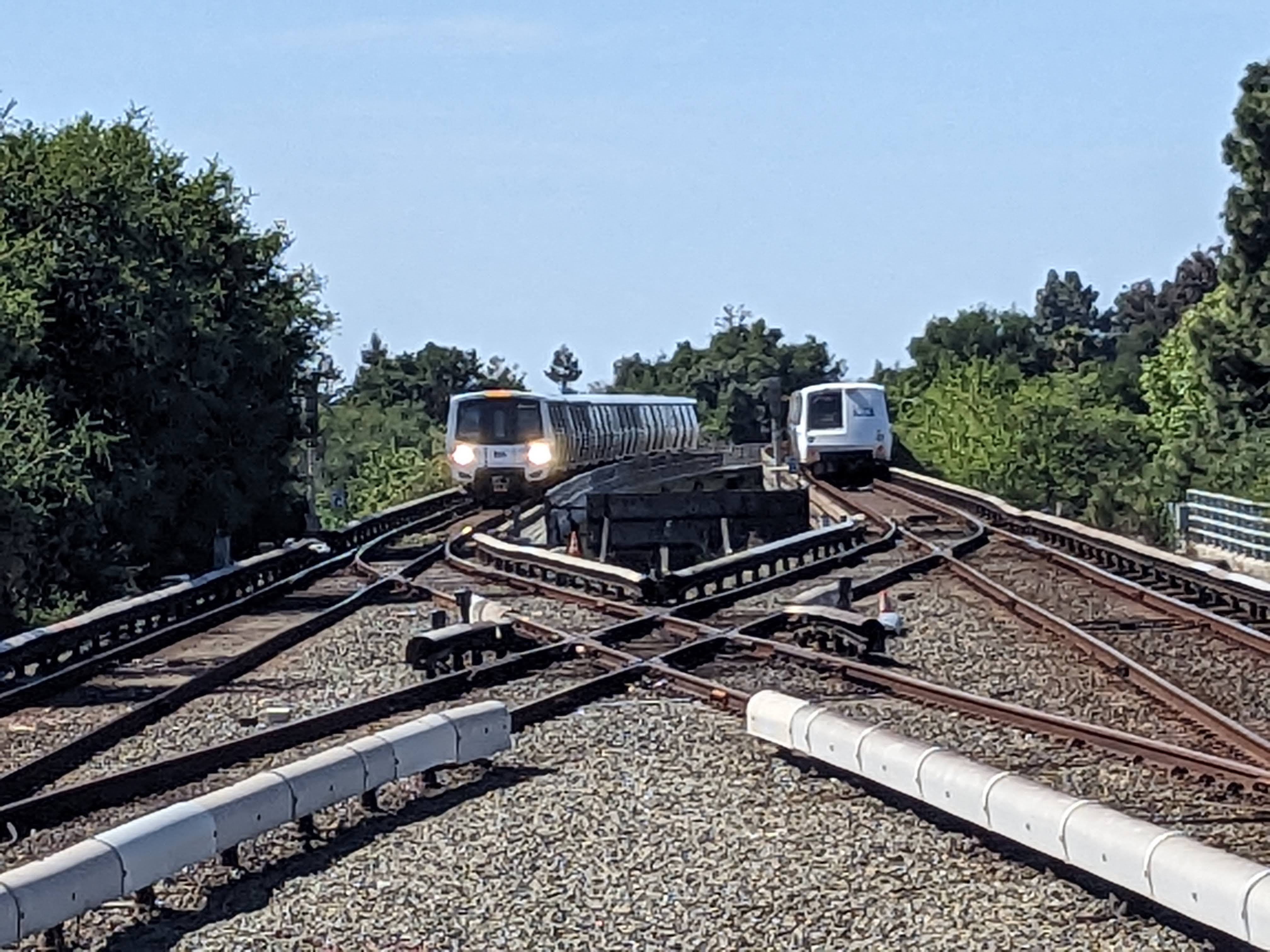Image 2 of 2 of the last legacy train leaving Fremont Station at 3:35 pm. The new BART train is on the left.